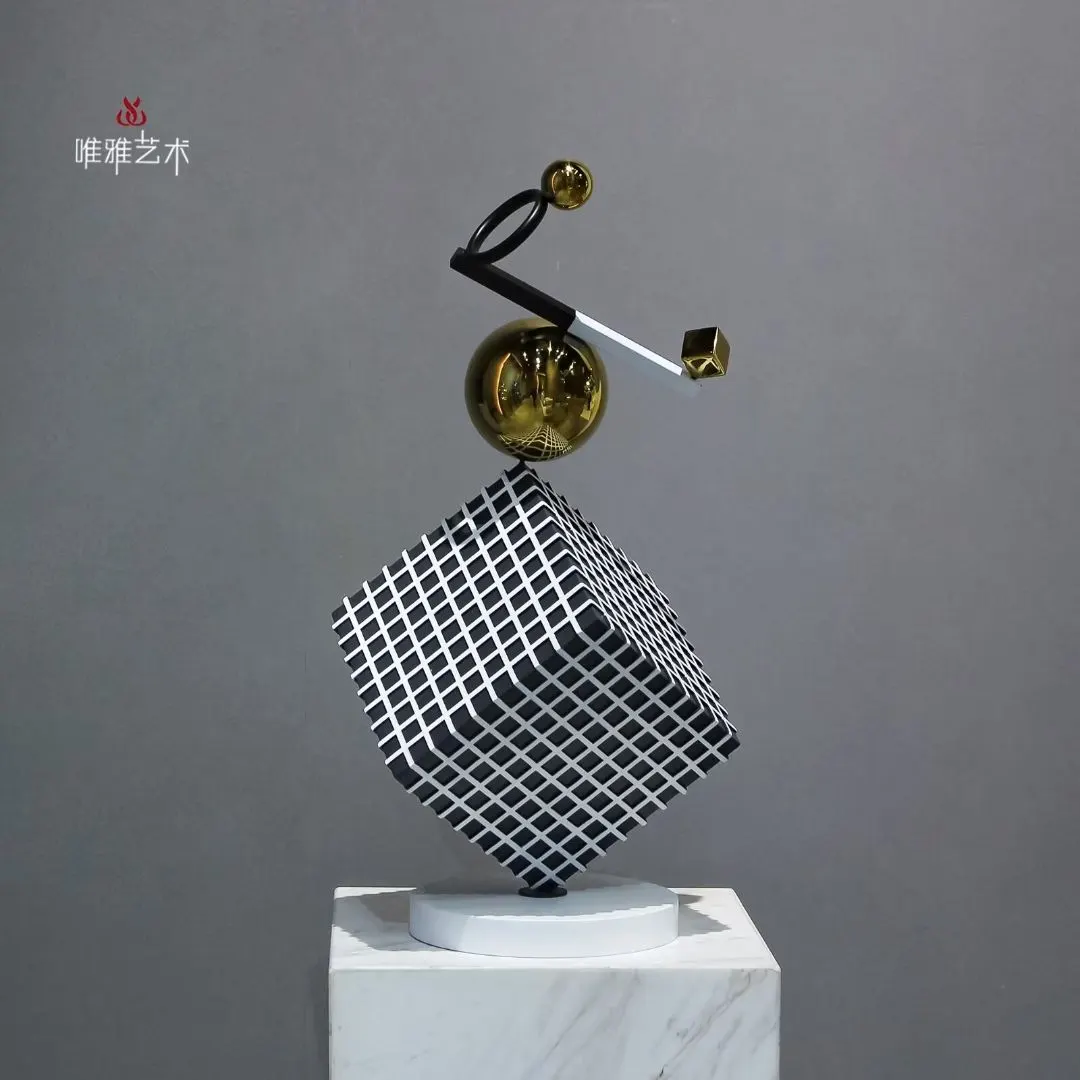 Large outdoor metal sculpture on a low plinth in a landscaped setting