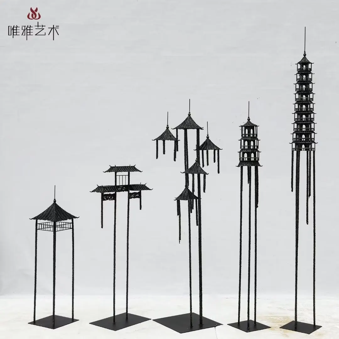 Large metal sculpture installed outdoors in a landscaped setting